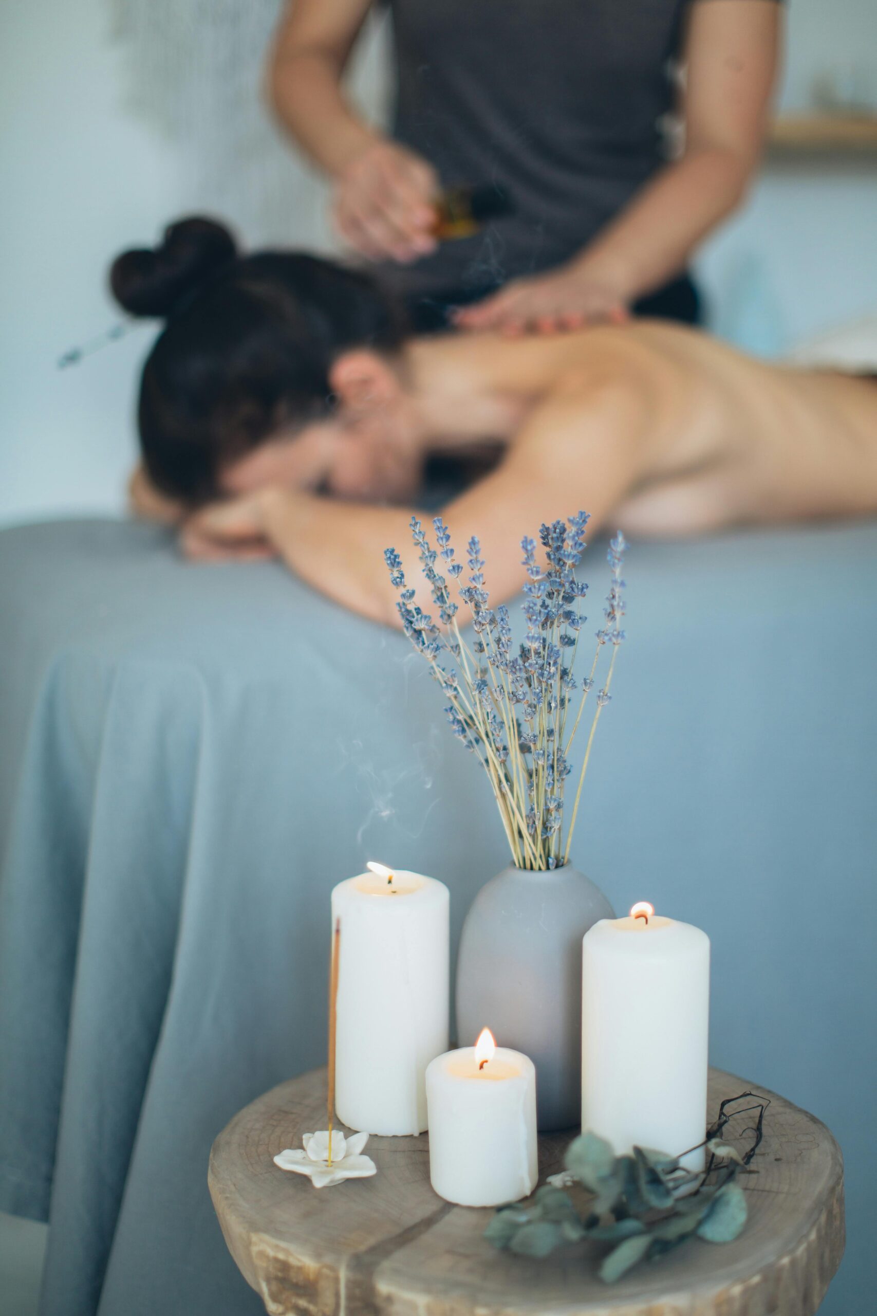 pexels-photo-3865773-3865773 Soothing spa scene with massage, lavender, and candles promoting relaxation.